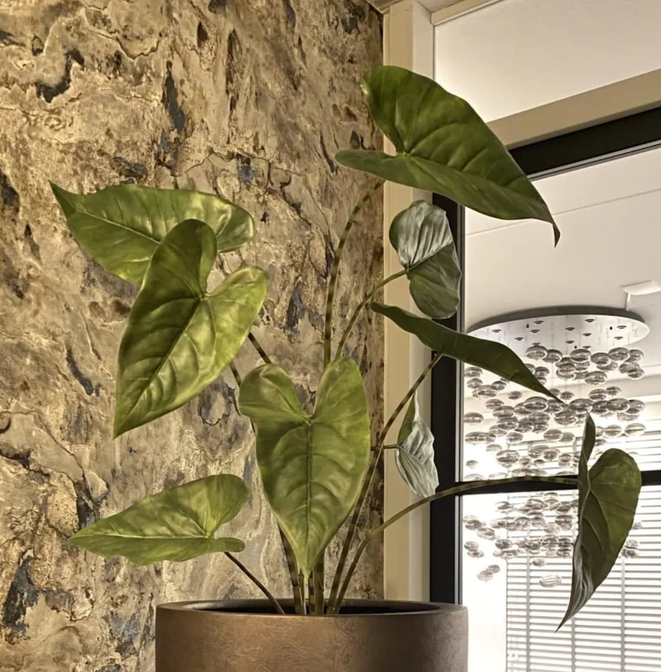 Kunstplant groot met brede groene bladeren in bronzen pot
